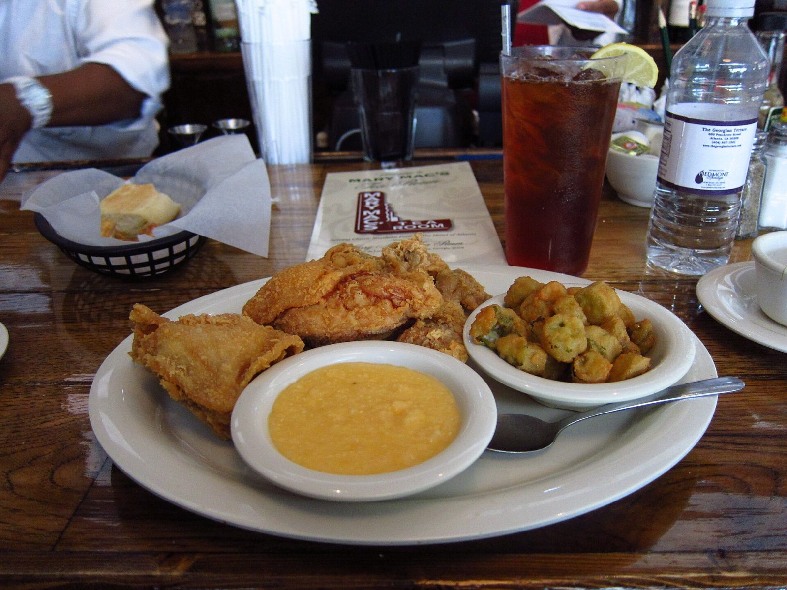 A Southern plate of fried chicken, grits and fried okra with sweet tea