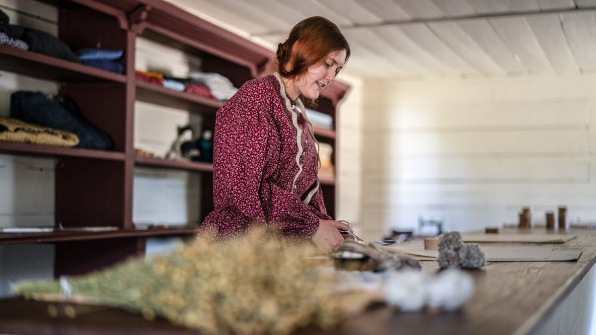 A dressmaking interpreter at Historic Westville.