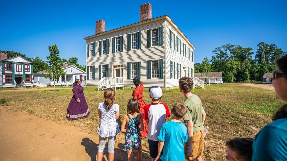 A tour group outside Westville's county courthouse in 2019.