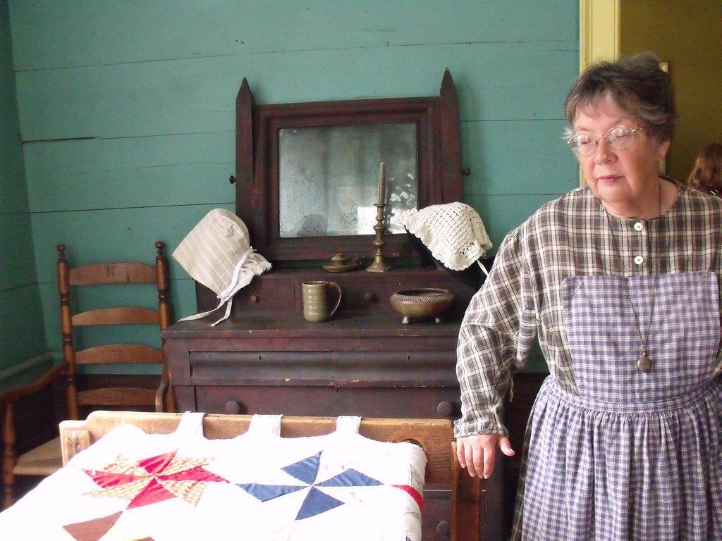 An interpreter in an 1850s bedroom at Westville's former Lumpkin site in 2012.